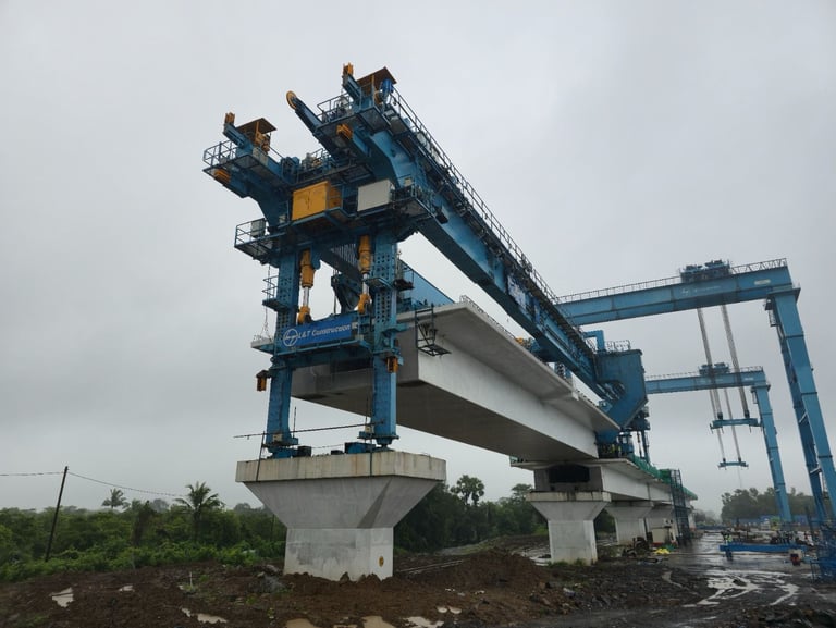 A heavy-duty blue girder launcher crane installs concrete segments for a highway bridge project.