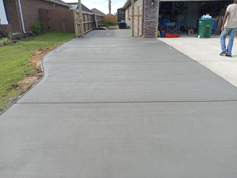 Newly poured concrete driveway in Navarre FL with smooth, clean finish by local concrete contractor