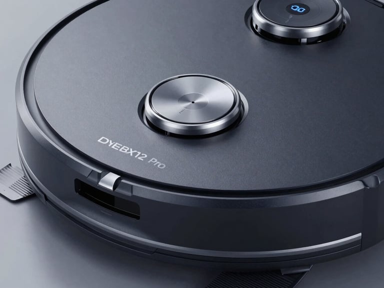 Macro shot of DEEBOT X12 Pro Omni in dark textured casing, silver accents, showing the targeted stain removal spray nozzle, studio lighting