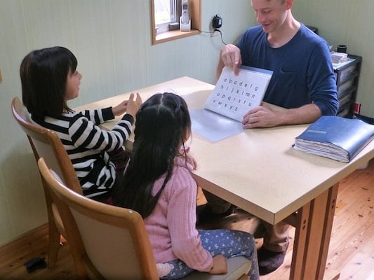man teaching kids abcs