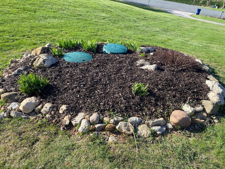 Expert mulch installation and stone edging around septic covers—custom lawn care solutions in Appleton