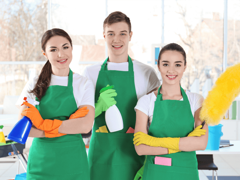 a group of people in green aprons and green aprons