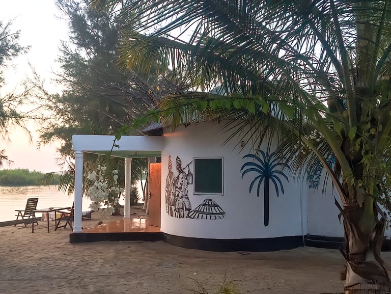 A vibrant image of Stala Adventures Lodge in Kartong, set in a lush natural environment with tall pa