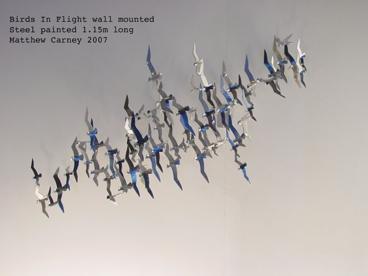 Steel sculpture of a flock of shearwaters in flight