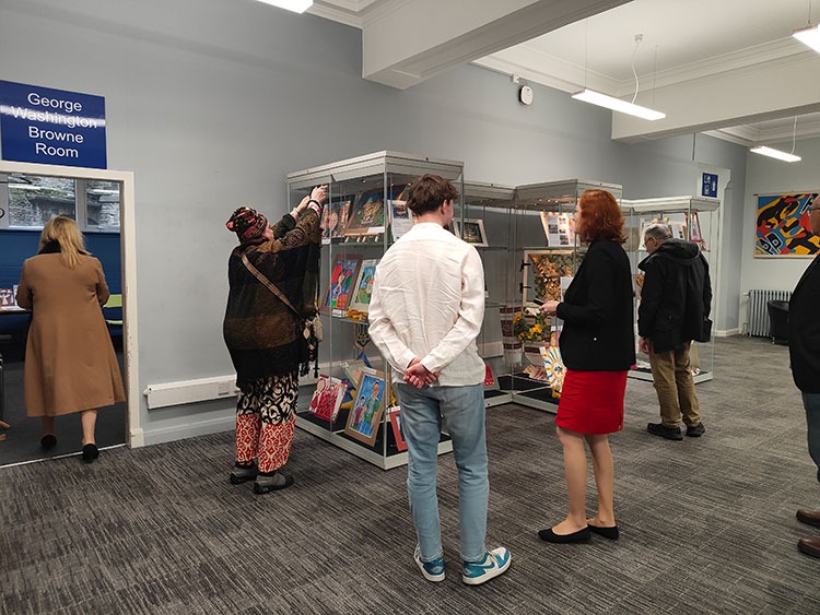 People looking at the display of Ukrainian children's paintings