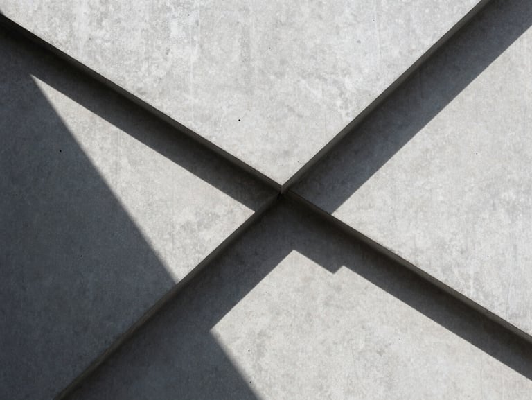 Abstract geometric shadows cast on a light gray concrete wall, sharp lines, minimalist composition.