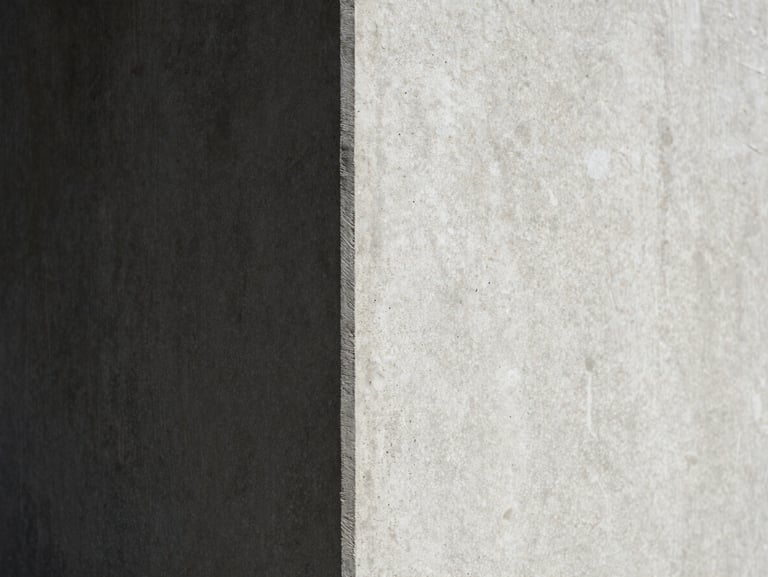 Minimalist close-up of a concrete corner, sharp diagonal shadow dividing the frame, high-contrast natural daylight, editorial texture.