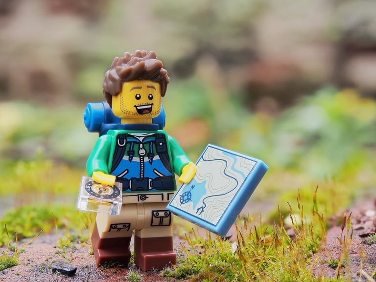 a lego - man holding a map and a map