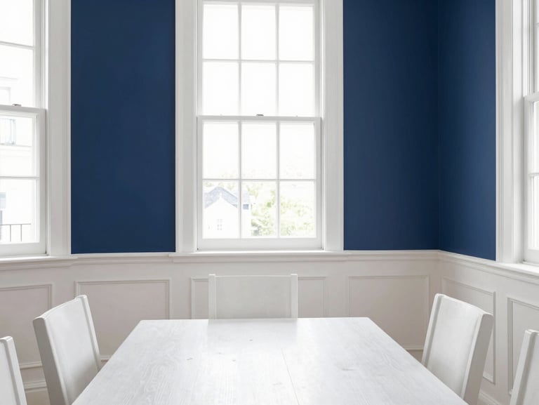 Bright editorial photography of a beautifully painted dining room with crisp white wainscoting and deep navy blue walls, sharp natural daylight streaming through a large window, highlighting flawless trim lines and immaculate paint finishes, 35mm architectural lens.
