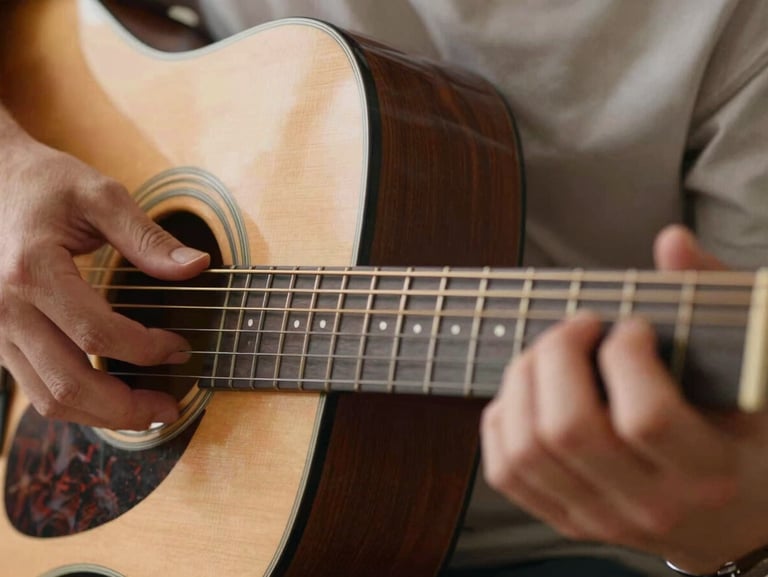Close-up of acoustic guitar frets with hands positioning a chord, warm natural light, editorial photography.