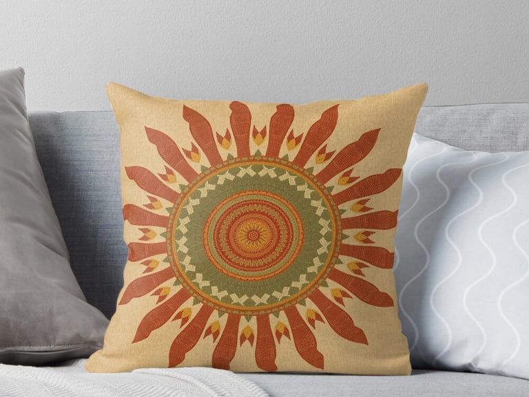 Throw pillow with vintage orange and yellow mandala.