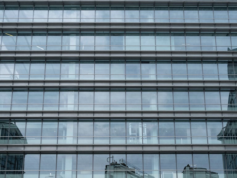 Commercial infrastructure asset, glass and steel structural grid, clean lines, architectural scale.