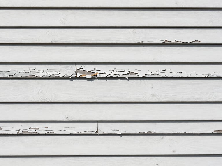 Close-up of weathered, peeling exterior wood siding on a Mobile home before preparation, harsh daylight, showing cracks and decay
