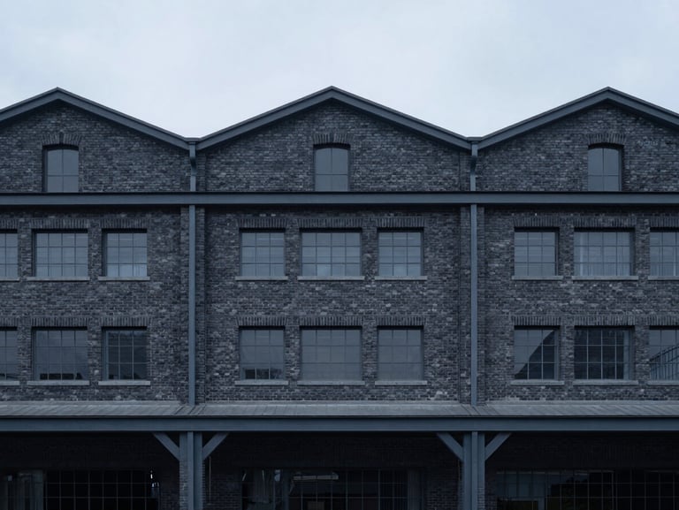 Minimalist architectural photography of a rehabilitated industrial brick warehouse with modern steel frames, cool overcast day