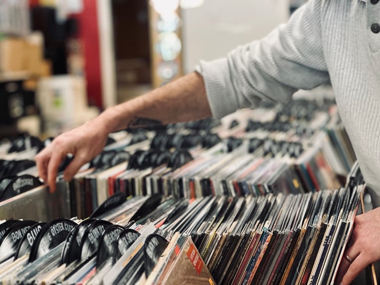 Person crate diving through vinyl records