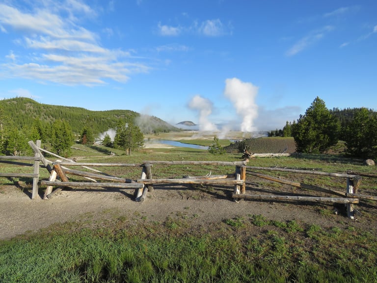 Venting geysers, hilly landscape and an old fence