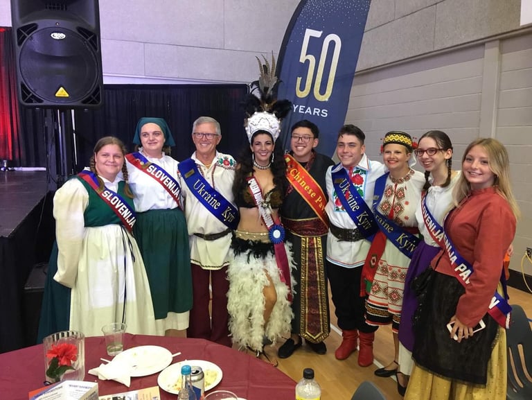 a group of people standing around a table