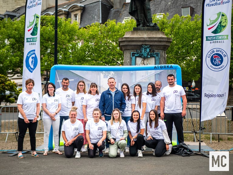 a group of people standing around a soccer goal