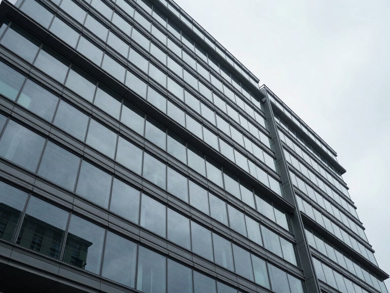 Wide architectural perspective of a modern glass and steel corporate facade, sharp geometric angles, cool overcast daylight, minimal composition.
