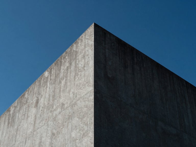 Abstract geometric concrete structure representing a sharp peak, high-contrast daylight, minimalist architectural photography