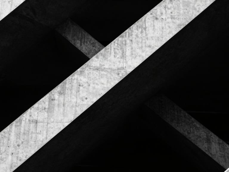 Abstract architectural geometry, sharp concrete angles, dramatic shadows, stark high-contrast monochrome