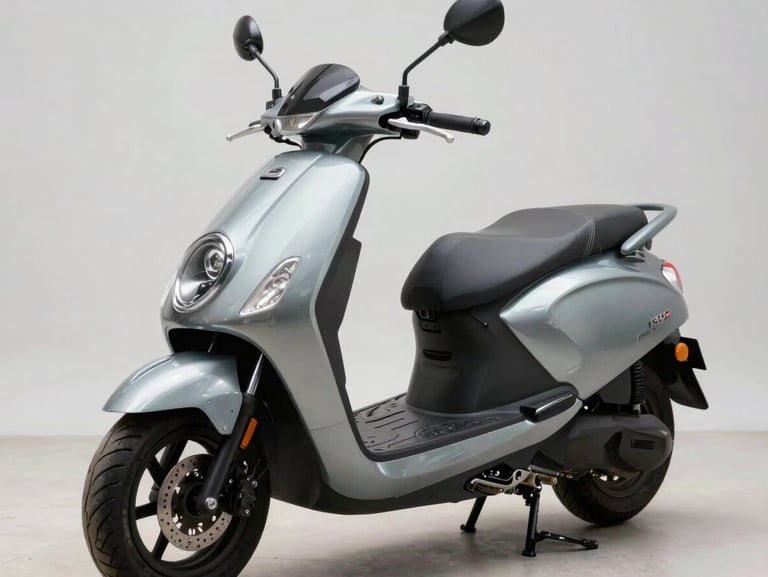 45-degree quartering shot of a 150cc commuter scooter on a clean studio surface, neutral daylight revealing the front apron, headlamp cluster, and instrument console detail, no rider present