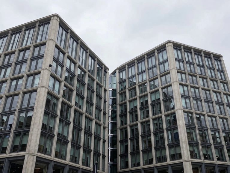 Symmetrical architectural photography of a modern commercial building in London, overcast UK daylight, showcasing steel and concrete junctions.