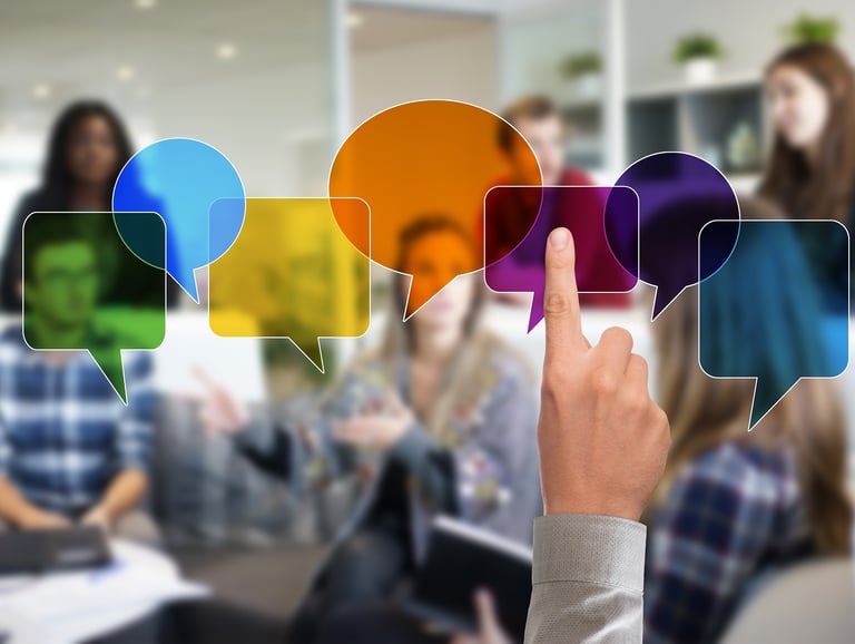 Person pointing at idea bubbles in a group, symbolizing communication and connection.