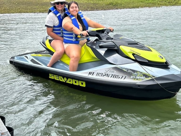 a woman and a man riding a jet skis