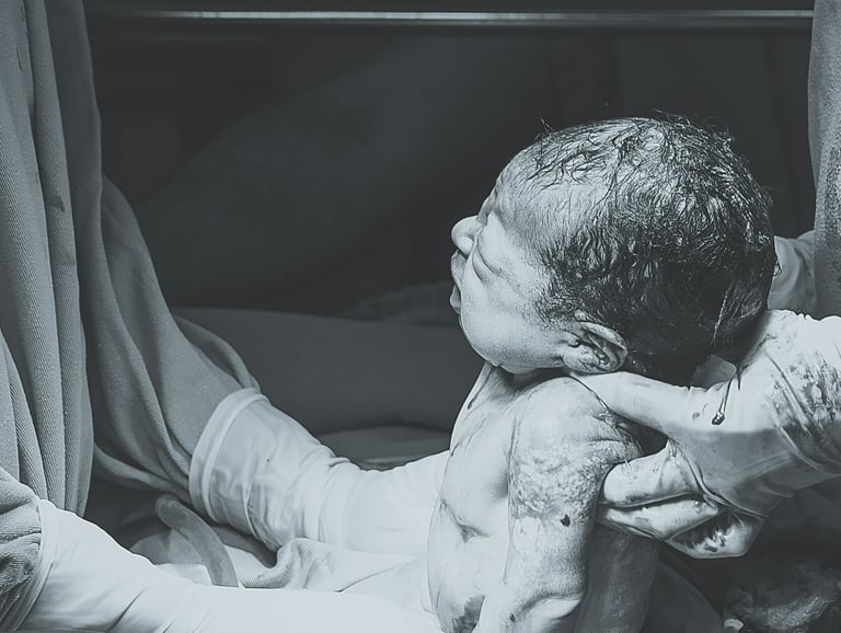 doctor holding newborn baby