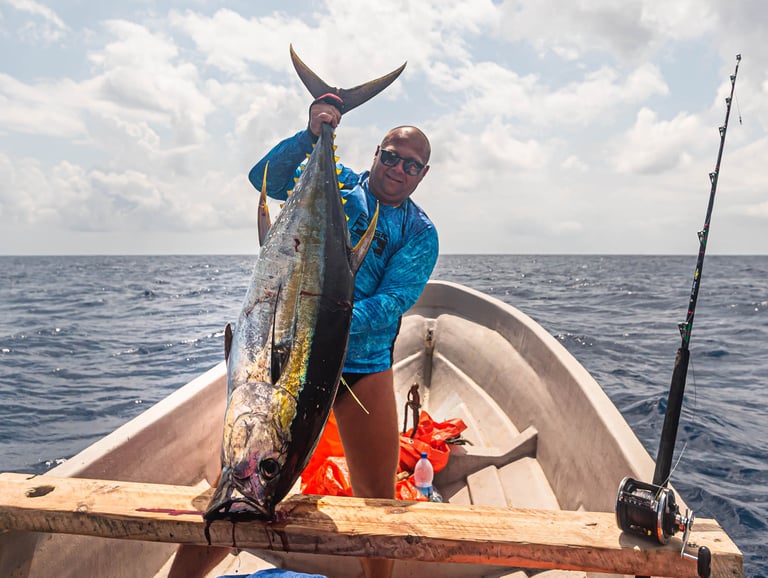 Zanzibar Fishing Trips – happy angler proudly displaying a caught Yellowfin Tuna in Zanzibar