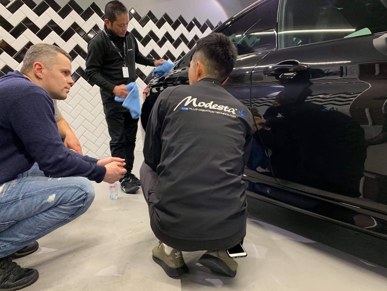 a man is sitting on the ground while another man is standing next to him