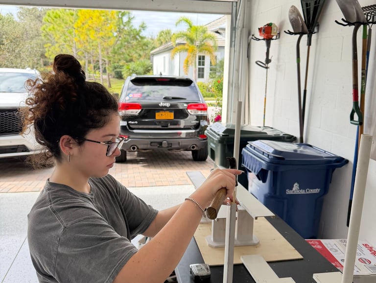 FL DECA Sunshine Skyway bridge being assembled with popsicle sticks and wood, showcasing teamwork an