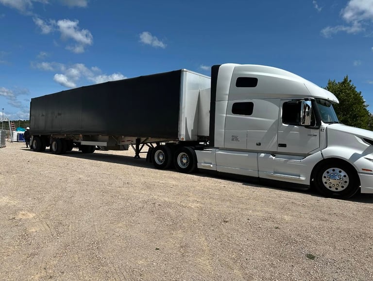 Transport Trucks on site delivering equipment to a festival.