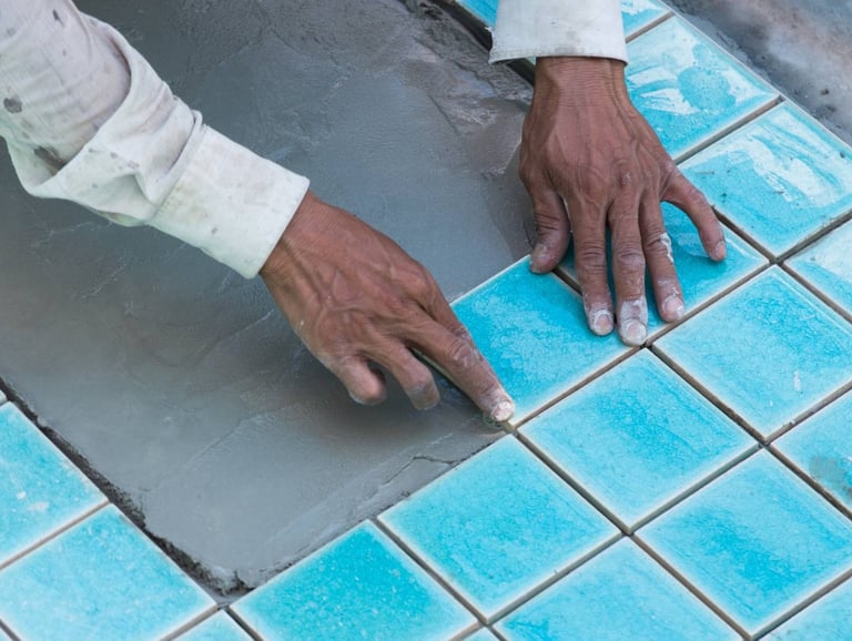 Pemasangan keramik berwarna biru oleh tukang dari Bali Pool Care