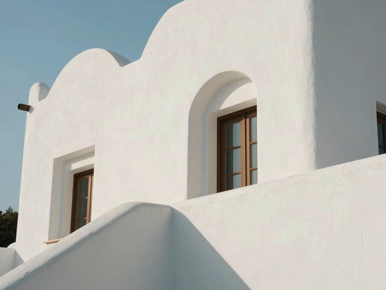 Clean, luminous architectural detail of a Mediterranean-style building with soft white curves and natural light, Spanish-speaking region context, serene and minimalist.