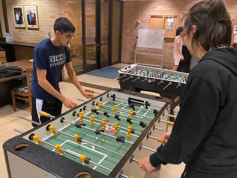 Lovetteers playing foosball in Lower Commons