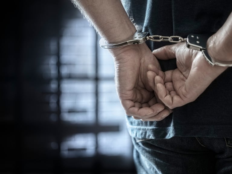 person in handcuffs from behind