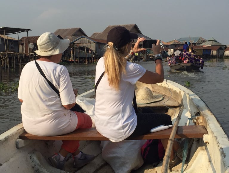 Tourists Visiting Ganvie stilt village during a Multi-country Trips of Senegal, Ivory Coast & Benin