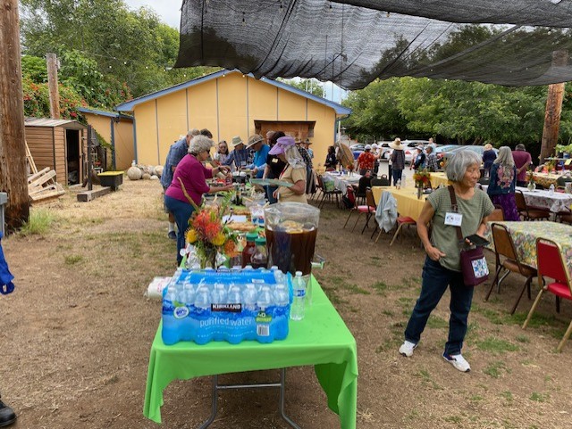 The 2024 potluck: food table and guests getting lunch
