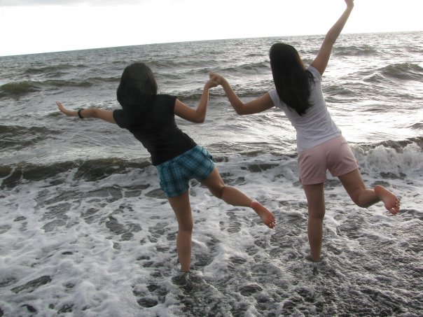 young girls dancing on the beach