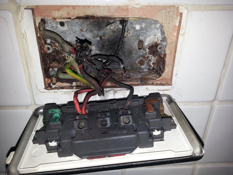 Electrical fault finding revealing heat damage and failed connections within a kitchen socket outlet