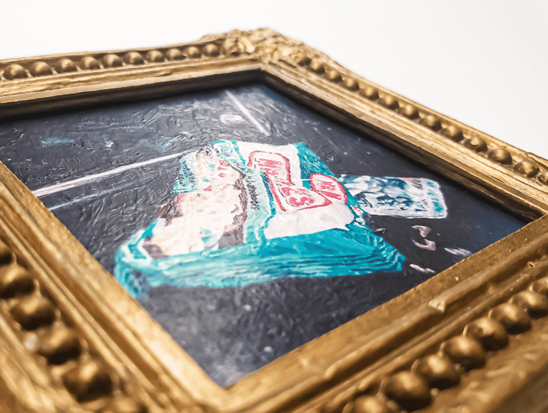 a close-up photo of a miniature painting magnet in a gold gilded frame