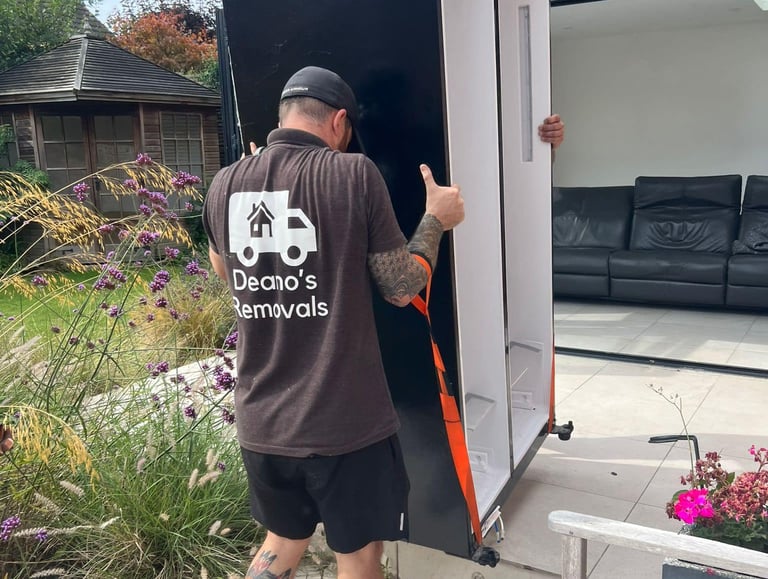 deanos removals worker carrying a fridge