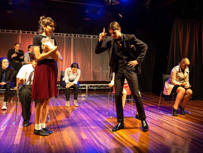 a man and woman in a stage setting