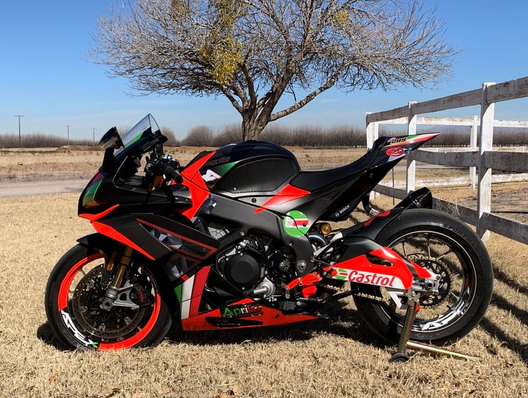 aprilia RSV4 motorcycle wrapped with fluorescent red. wrapped wheels. Italian colors with carbon