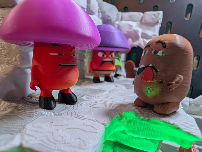 A bemused Shrooman looks on at an extremely stupid potato boy. Original creature creations, 3d print