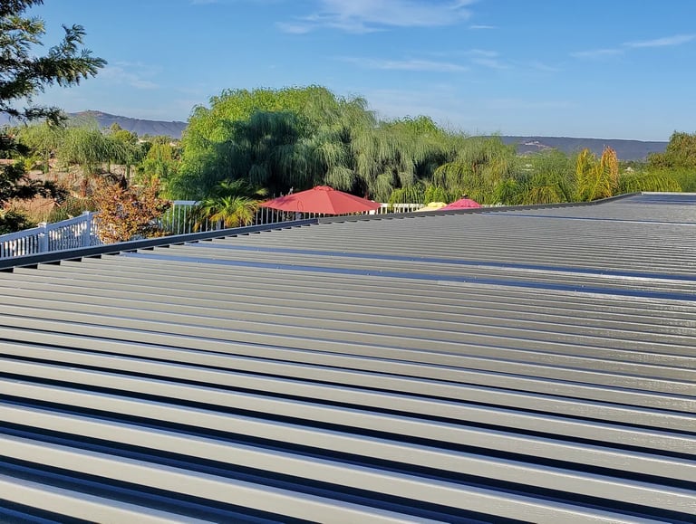 Top of dark grey patio cover overlooking trees and the Santa Rosa Plateau.