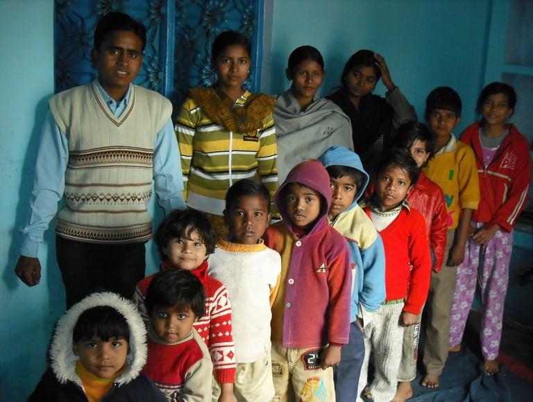 a group of people standing in front of a blue wall