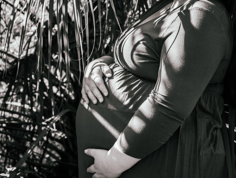 a pregnant woman in a dress with a baby in her belly